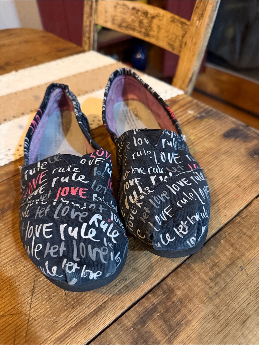 Toms Kids Black Slip-On Shoes with Pink & White 'Love' Script